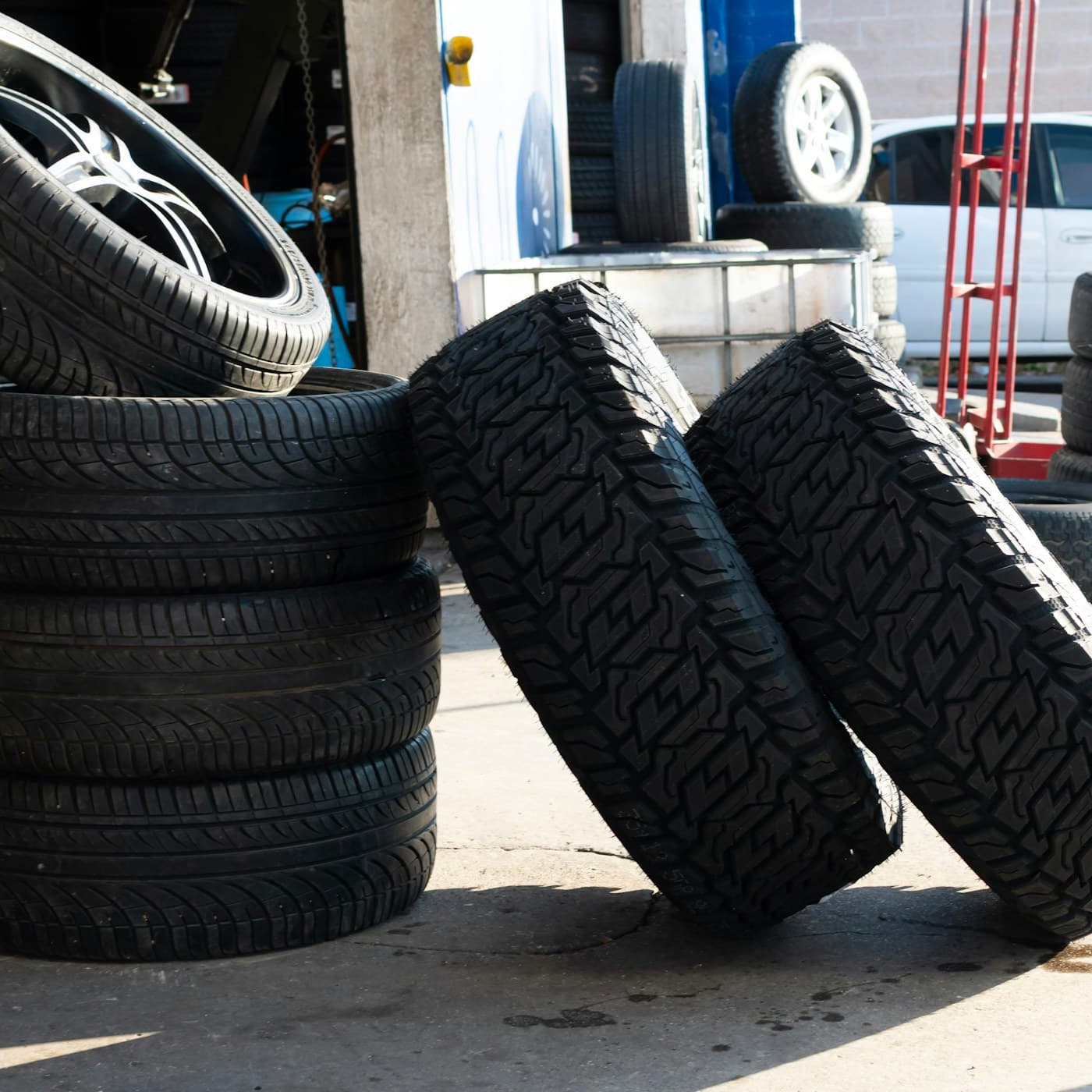 Stack of tyres outside a garage — replace with a real KC Motors tyre service image